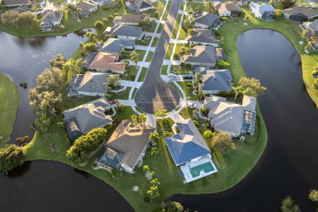 Aerial evening view of spacious family houses in Florida suburban area. Real estate development in American suburbs.