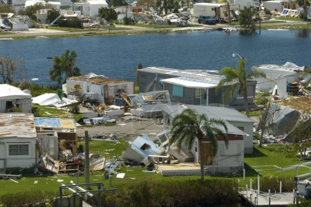 Aerial view of natural disaster consequences. Severely damaged by hurricane Ian mobile homes in Florida residential area.