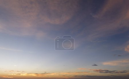 Photo for Colorful sunset sky with setting sun behind vivid orange and yellow clouds. - Royalty Free Image