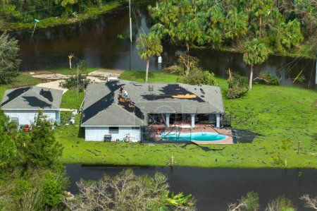 Consequences of natural disaster. Heavy flood with high water surrounding residential houses after hurricane Ian rainfall in Florida residential area.