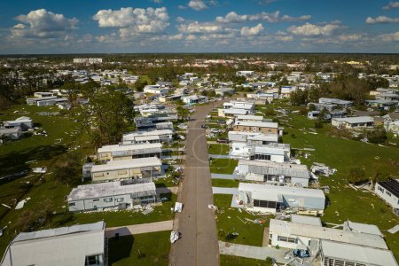 Photo for Severely damaged houses after hurricane Ian in Florida mobile home residential area. Consequences of natural disaster. - Royalty Free Image