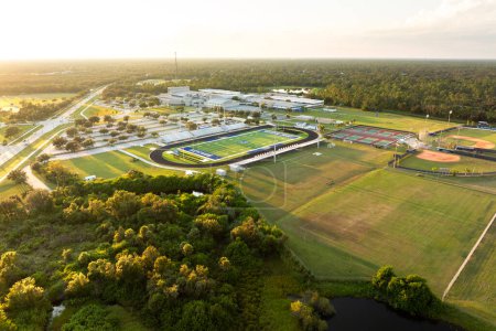 Sports facilities at public school in North Port, Florida. American football stadium, tennis court and baseball diamond sport infrastructure.