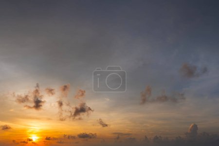 Photo for Bright colorful orange and yellow clouds on horizon. Beautiful sunset sky scenery. - Royalty Free Image