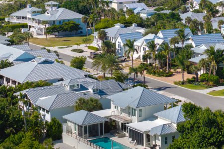 Teure Villen zwischen grünen Palmen in Vororten im Südwesten Floridas, USA. Luftaufnahme des wohlhabenden Uferviertels.
