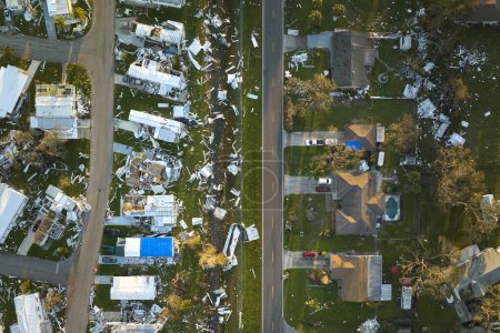 Severely damaged by hurricane Ian houses in Florida mobile home residential area. Consequences of natural disaster.