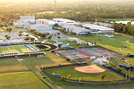 Sports facilities at public school in North Port, Florida. American football stadium, tennis court and baseball diamond sport infrastructure.