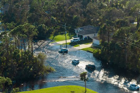 Vue aérienne de la rue inondée après les précipitations ouragan avec des voitures de conduite dans le quartier résidentiel de Floride. Conséquences des catastrophes naturelles.
