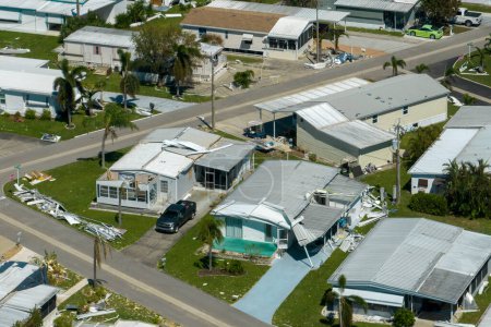 Aerial view of heavily damaged by hurricane Ian houses in Florida mobile home residential area. Consequences of natural disaster.