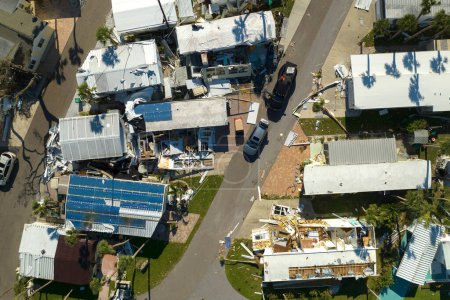 Destroyed by strong hurricane winds suburban houses in Florida mobile home residential area. Consequences of natural disaster.