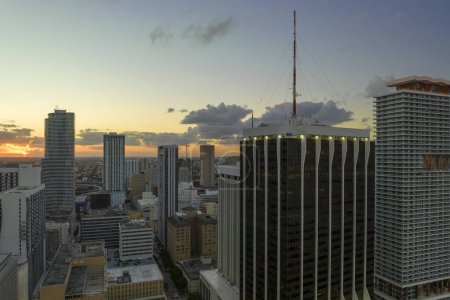 Aerial view of downtown office district of of Miami Brickell in Florida, USA at sunset. High commercial and residential skyscraper buildings in modern american megapolis.