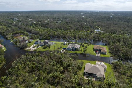 Aftermath of natural disaster. Surrounded by hurricane Ian rainfall flood waters homes in Florida residential area.