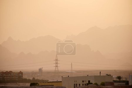 Photo for Sunset landscape with remote hotel complex against dark mountain peaks in egyptian desert. - Royalty Free Image