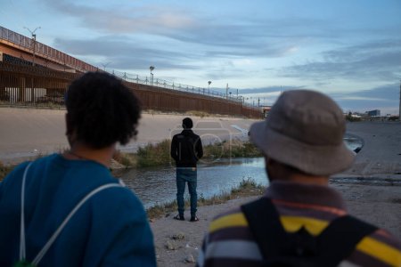 Foto de Juárez, México, 28-11-2022: Migrantes de Venezuela esperan en la frontera entre México y Estados Unidos el fin del título 42, una medida que permite la expulsión inmediata de migrantes que buscan asilo. - Imagen libre de derechos