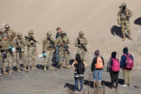 Photo for Thousands of migrants from Latin America wait at the southern border of the United States for Title 42 to end, the Texas Governor ordered the Texas National Guard to maintain surveillance on the border to prevent the massive entry of migrants - Royalty Free Image