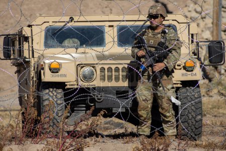 Photo for Juarez, Mexico, 12-21-2022: Texan National Guard places wire and barbed wire on the banks of the Rio Grande to prevent migrants from crossing into the United States to request humanitarian asylum. - Royalty Free Image