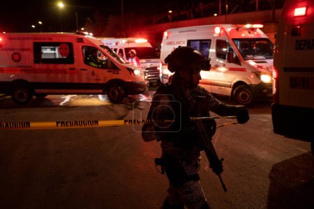 Photo for Police, Firefighters, and Paramedics Work to Extinguish a Fire at a Migrant Detention Center Where 38 Migrants Lost Their Lives - Royalty Free Image