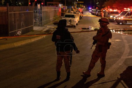 Photo for Police, Firefighters, and Paramedics Work to Extinguish a Fire at a Migrant Detention Center Where 38 Migrants Lost Their Lives - Royalty Free Image