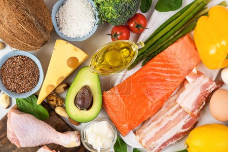 Balanced low carb keto diet food. Food sources of protein, healthy fats, carbs. Top view. Fish, meat, vegetables, fruits, nuts, eggs for ketogenic diet