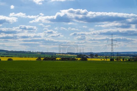Green field and high voltage line