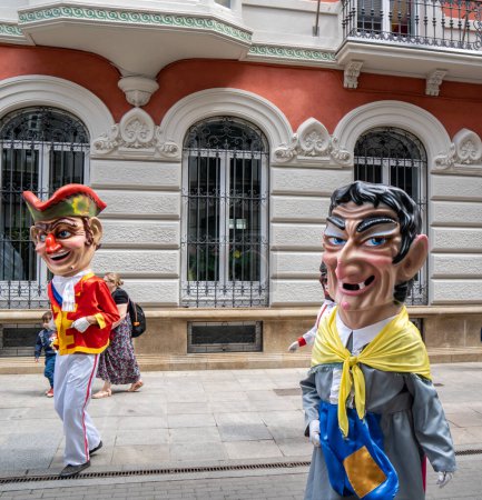 Photo for Big heads and giants dancing down the street of pontevedra in the festivities of the pilgrim - Royalty Free Image