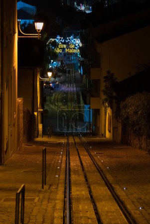 Photo for Urban tramway from the top illuminated with lampposts and at the bottom you can see the popular festivals of Viseu - Royalty Free Image