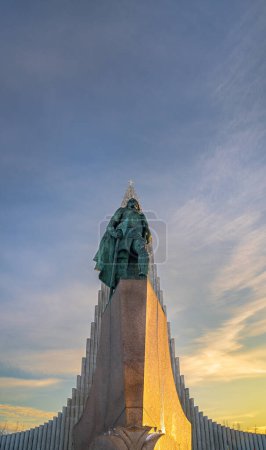 Photo for Statue of Leif Erikson, nicknamed the lucky first Viking explorer to reach North America lit in the early morning sun with Hallgrimskirkja cathedral behind - Royalty Free Image
