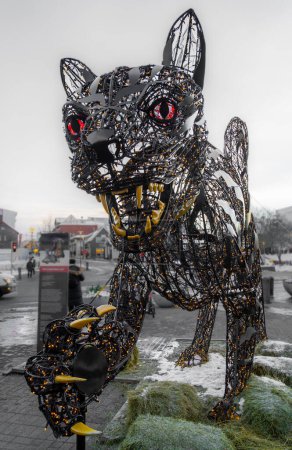 Photo for Large sculpture of the iron cat and christmas led lights Jolakotturinn in the center of reykjavik iceland, with its mouth open and a raised paw. - Royalty Free Image