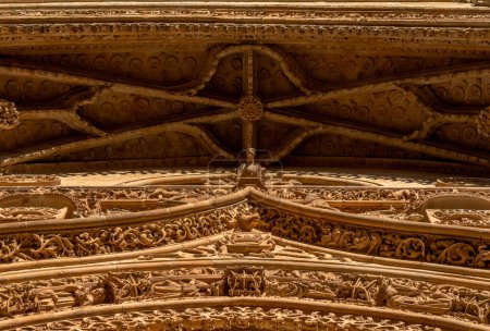 Photo for Detailed view from below of the ornaments on the cornice of the main door with bas-reliefs of fantastic animals, saints, chimeras and beasts of the New Cathedral of Salamanca - Royalty Free Image