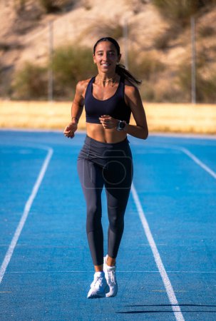 Photo for Beautiful young slim tanned girl, dressed in tight sportswear, e - Royalty Free Image