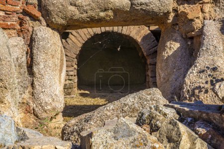 Photo for Ruins of brick arched exterior door of a hall of gladiators or beast cages in the Merida amphitheater, made of rock blocks and bricks with a sand and earth floor. Archaeological complex. - Royalty Free Image