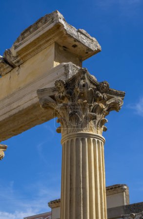 Photo for Detail of the ornate marble column moldings and Corinthian style capital of the well-preserved Roman Temple of Diana under a clear blue sky. Merida. - Royalty Free Image