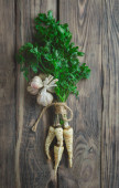 Parsley and garlic on wooden background. Fresh organic parsley herb leaves. Parsley and garlic.The concept of natural and healthy nutrition. From the garden. Cooking. Vegan food. Useful product. Poster #647378018