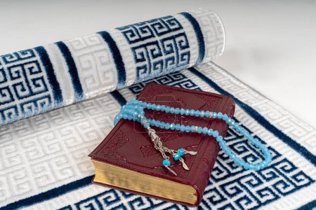 Quran,Women's scarf with embroidery ,muslim rosary beads seen on prayer mat.Ramadan Concept.