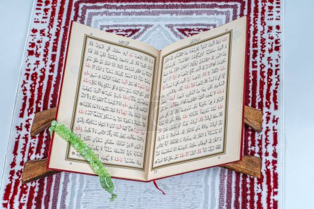 Photo for Turkey,Istanbul;2024 January 18 ; Islamic concept - The Holy Al Quran with written Arabic calligraphy of Quran and rosary beads or tasbih - Royalty Free Image