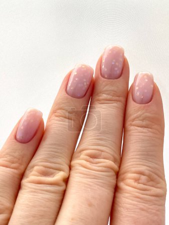Photo for New manicure. Womans hand with fresh manicure and delicate pink polish. The shape of the nail is a soft square.Edged manicure. High quality photo - Royalty Free Image