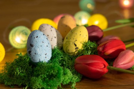 Photo for Easter colored eggs on green grass around tulips and wooden board Happy Easter. High quality photo - Royalty Free Image