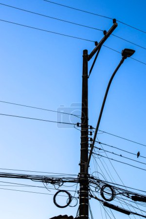 Photo for Many wires attached to the electric pole, the chaos of cables and wires on an electric pole, blue sky background, technological combination concept in Brazil - Royalty Free Image