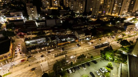 view from above of vehicle traffic and the bus lane of an avenue in the south zone of the city of Sao Paulo in the late afternoon