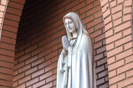 Statue des Bildes Unserer Lieben Frau von Ftima, Gottesmutter in der katholischen Religion, Unsere Liebe Frau vom Rosenkranz von Fatima, Jungfrau Maria mit dem Hintergrund einer Ziegelmauer in Brasilien