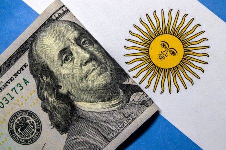 Dollar banknotes on an Argentine flag. Photo taken in studio