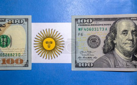 Dollar banknotes on an Argentine flag. Photo taken in studio