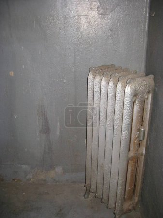 Photo for Antique Metal Heat Radiator In Empty Abandoned Room . High quality photo - Royalty Free Image