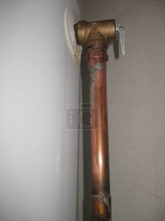 Foto de Copper Pipe with Fitting on Water Heater . High quality photo - Imagen libre de derechos