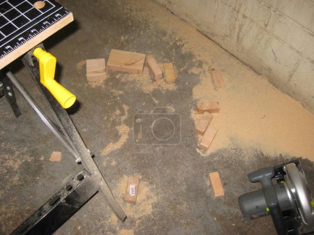 Photo for Cut Wood Scraps and Circular Saw on Garage Floor . High quality photo - Royalty Free Image