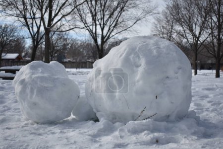 Foto de Large Snowballs Rolled in Minnehaha Falls Park, Minnesota Winter. High quality photo - Imagen libre de derechos
