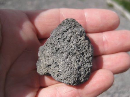 Photo for Black Lava Rock In Hand, Small Stone. High quality photo - Royalty Free Image