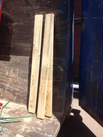 Foto de Tres 2x4 de madera en un contenedor de construcción. Foto de alta calidad - Imagen libre de derechos