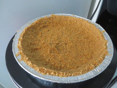 Photo for Graham Cracker Crust for a Cheesecake in Pie Tin. High quality photo - Royalty Free Image