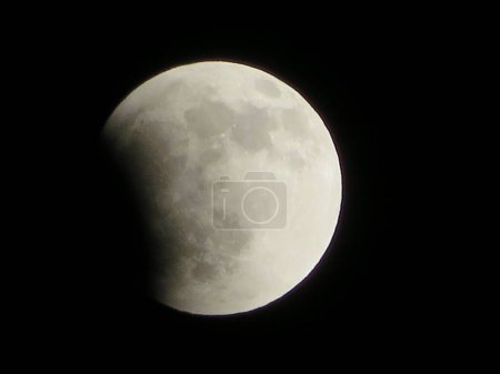 Partial Lunar Eclipse Moon Details in Clear Dark Night Sky. High quality photo