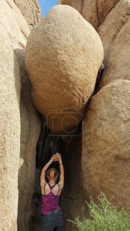 Fit Woman Stretching while Hiking in Joshua Tree National Park, California . High quality photo